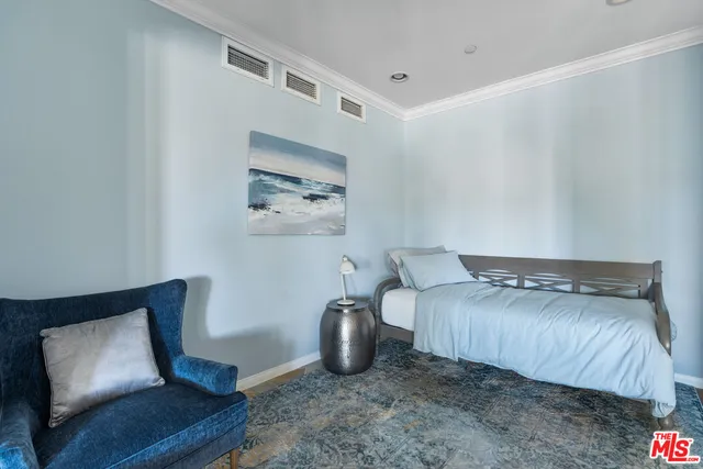 a bedroom with a bed and a chair