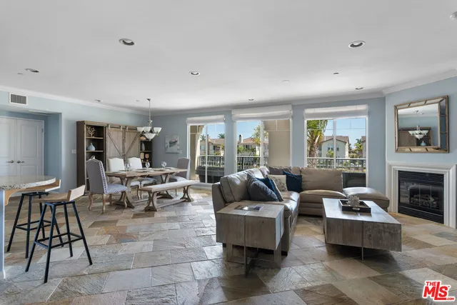 a living room with fireplace furniture and a table