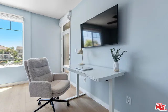 a dining room with furniture and wooden floor