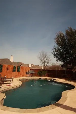 a view of a swimming pool with a yard