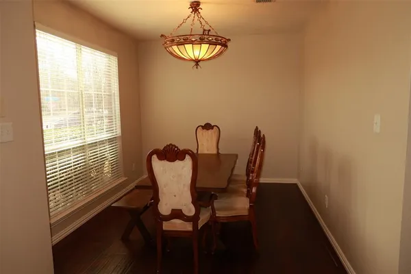 a view of a dining room with furniture and window