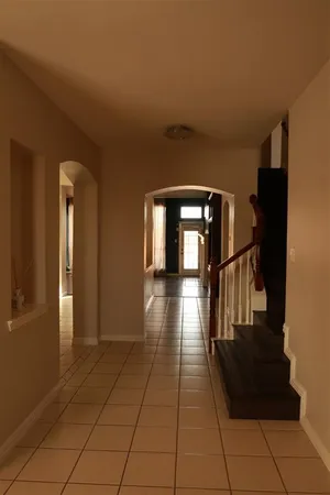 a view of entryway and hall with wooden floor