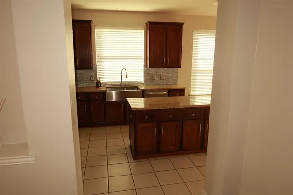 a kitchen with a sink and a stove top oven