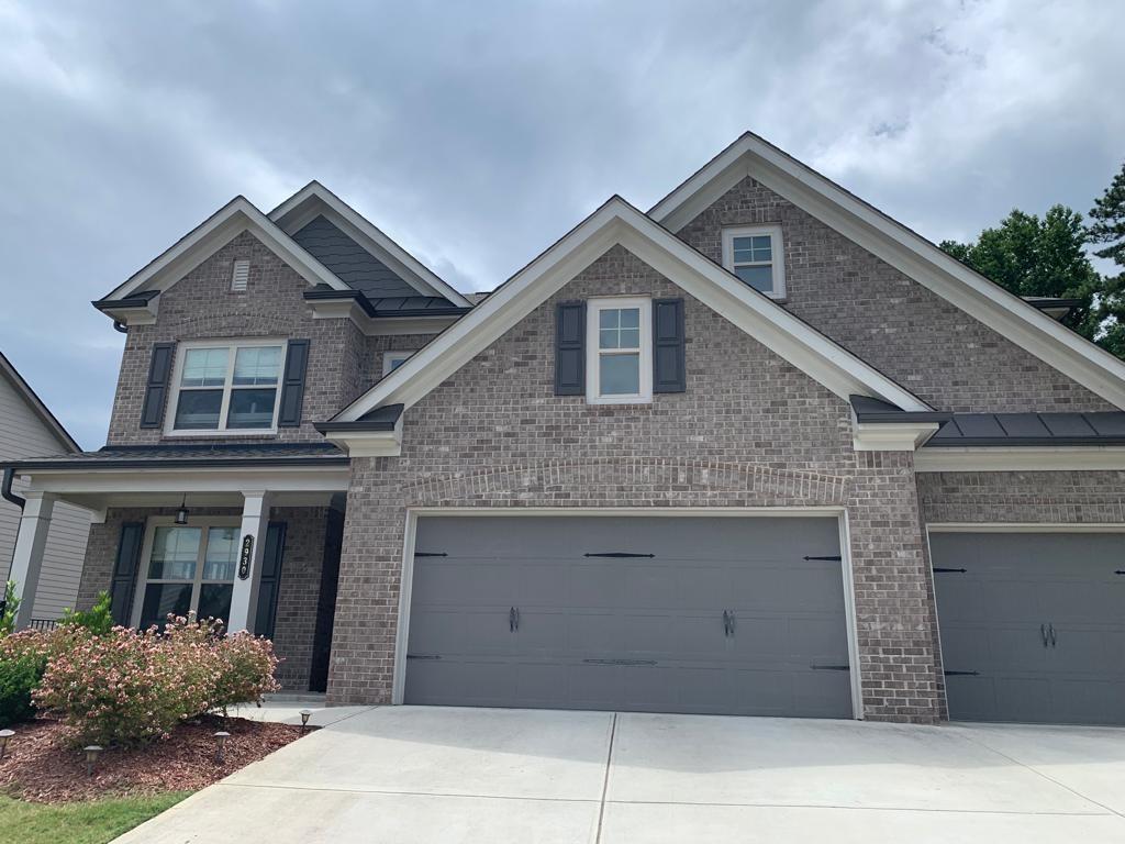 a front view of a house with garage