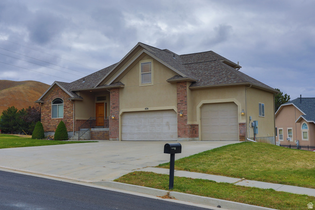 426 Deer Hollow Road Tooele, UT 84074 - Photo 29 of 37 Traditional-style house with stucco siding and concrete driveway