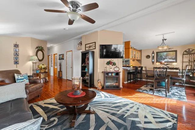 a living room with furniture a flat screen tv and kitchen view
