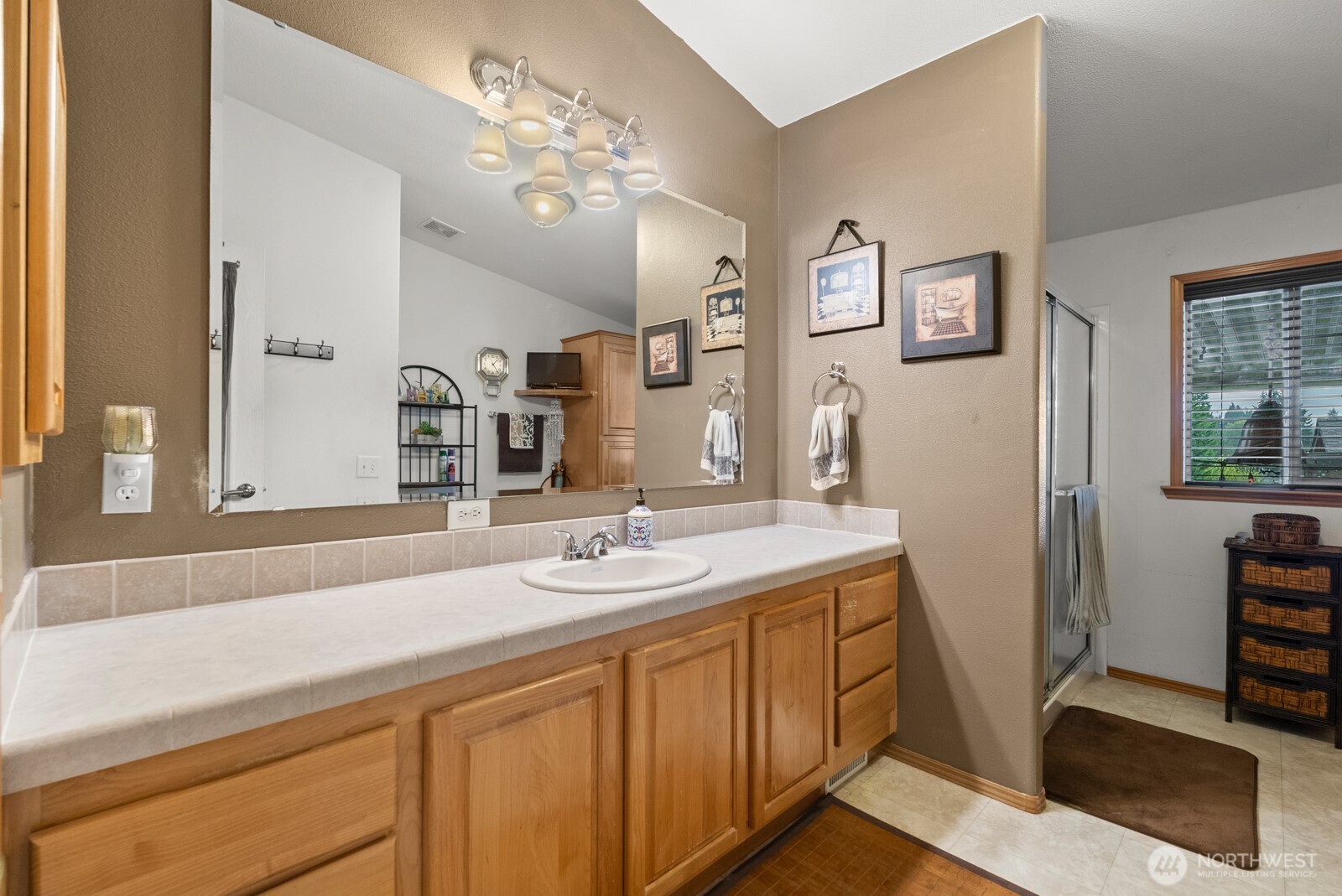 9314 Canyon Road East, Unit 39 Puyallup, WA 98371 - Photo 19 of 27 a bathroom with a sink double vanity and a mirror