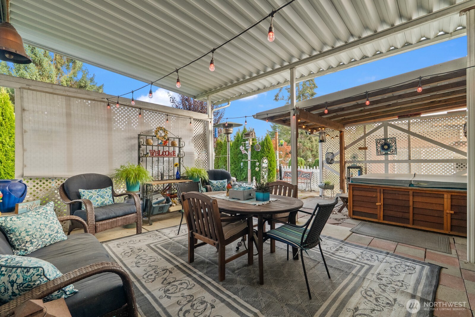 9314 Canyon Road East, Unit 39 Puyallup, WA 98371 - Photo 2 of 27 a view of a patio with a table and chairs and a barbeque