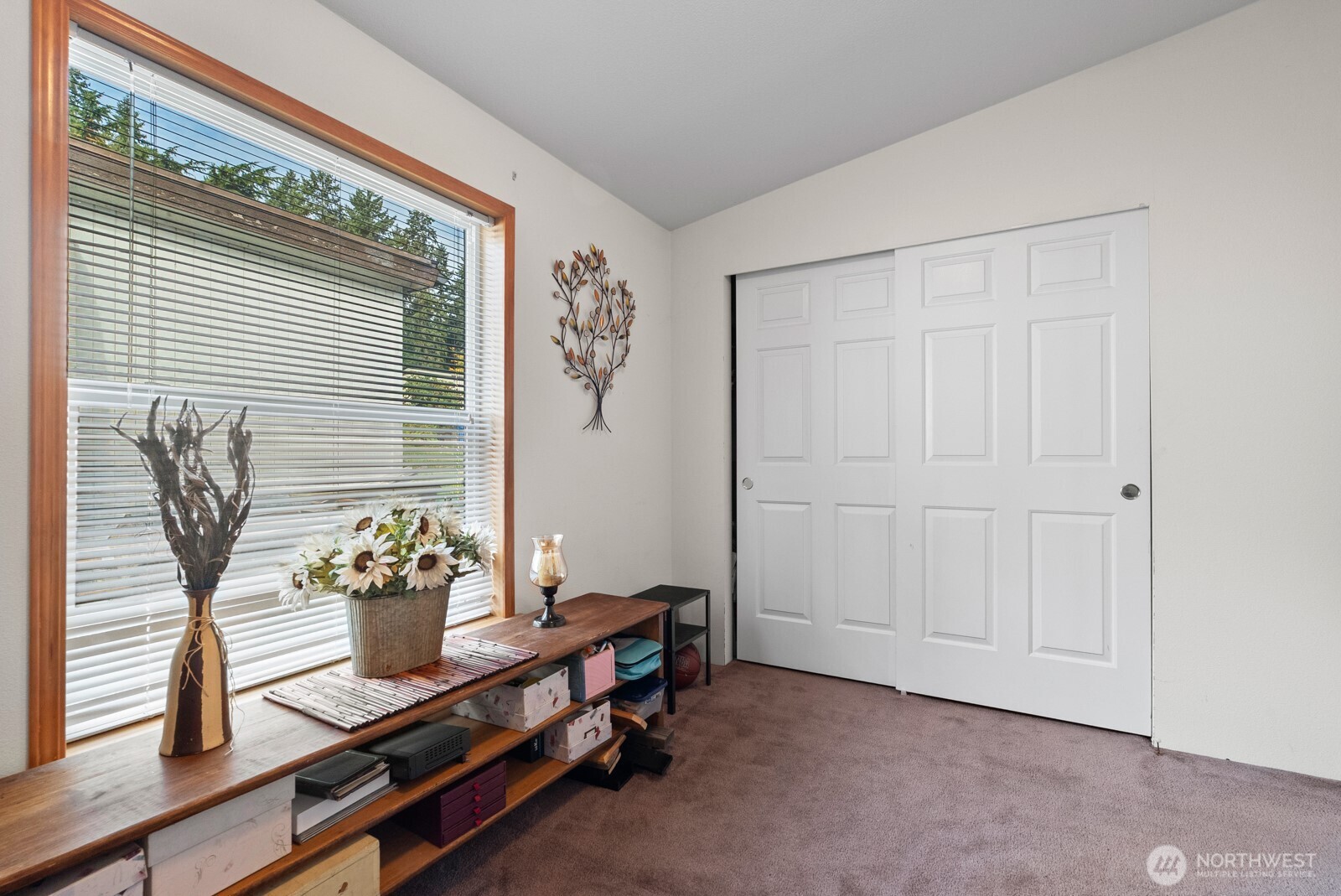 9314 Canyon Road East, Unit 39 Puyallup, WA 98371 - Photo 23 of 27 a room with painting on the wall and a window
