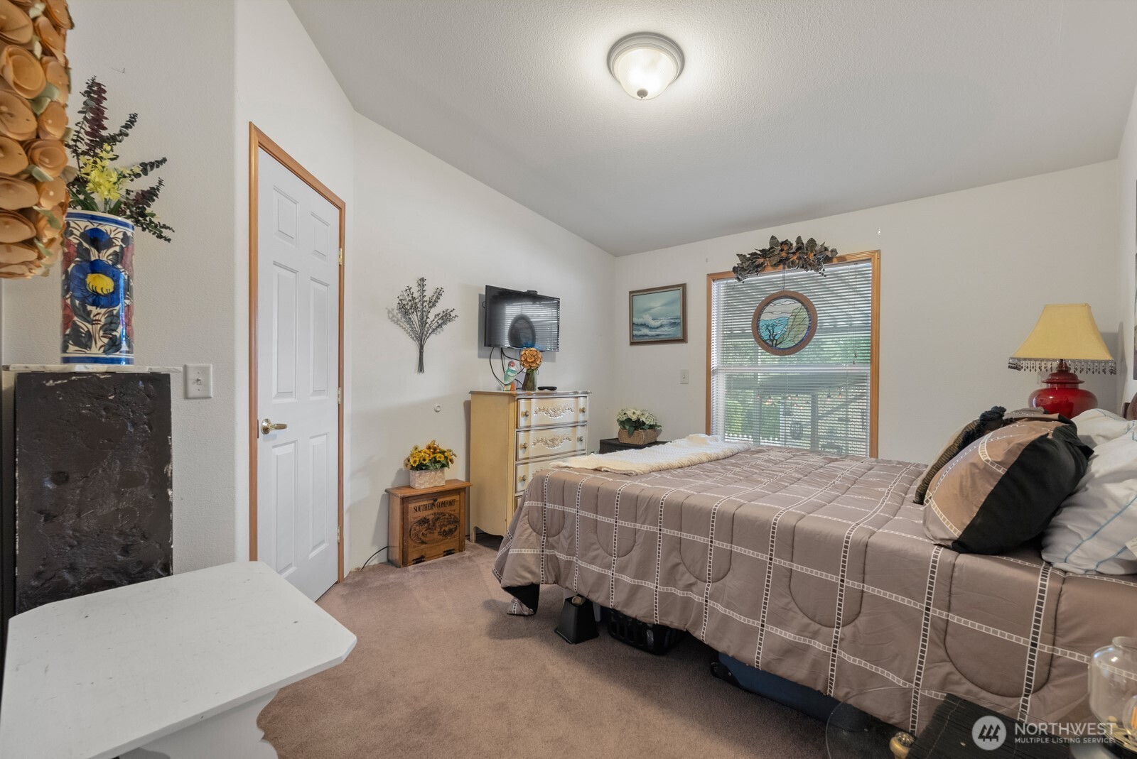 9314 Canyon Road East, Unit 39 Puyallup, WA 98371 - Photo 24 of 27 a bedroom with a bed and cabinets
