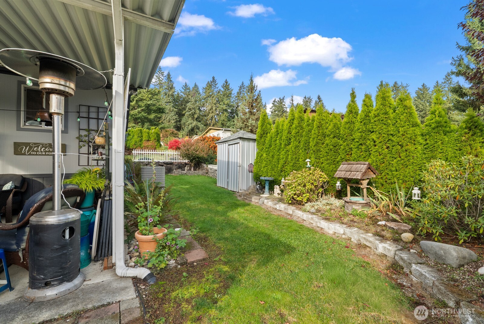9314 Canyon Road East, Unit 39 Puyallup, WA 98371 - Photo 26 of 27 a view of a patio with chair and tables back yard of the house