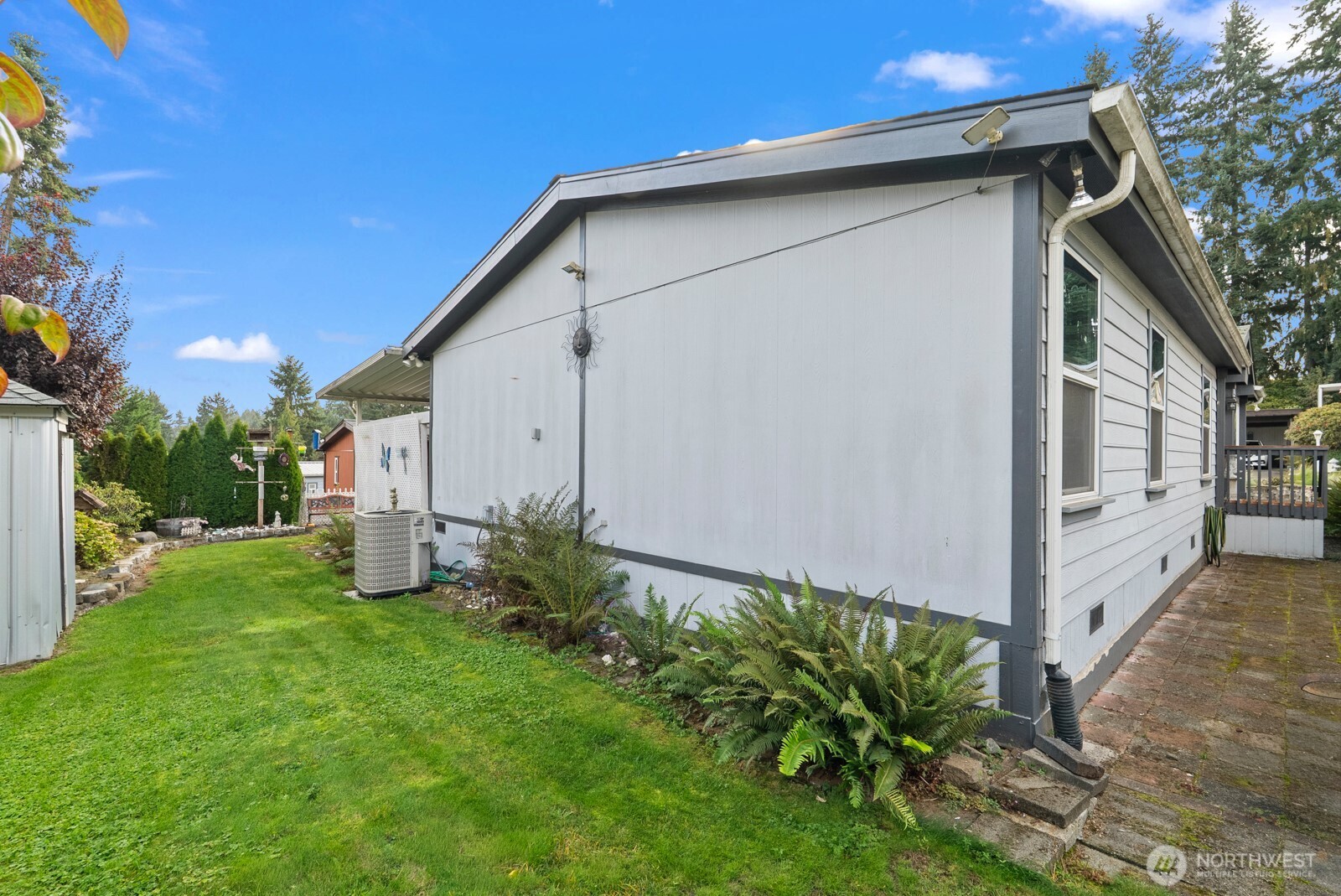9314 Canyon Road East, Unit 39 Puyallup, WA 98371 - Photo 27 of 27 a view of a house with backyard and garden