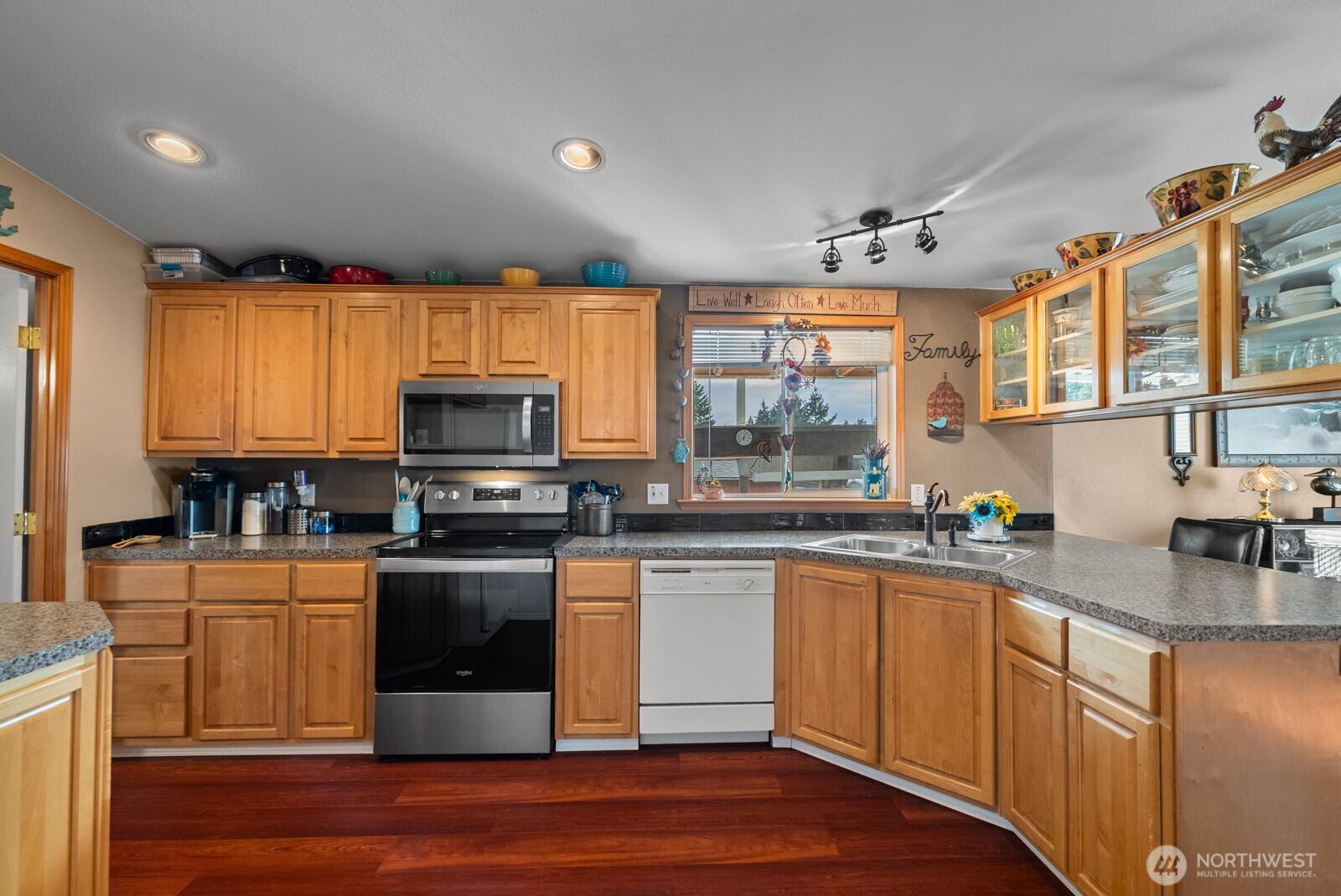 9314 Canyon Road East, Unit 39 Puyallup, WA 98371 - Photo 5 of 27 a kitchen with stainless steel appliances wooden cabinets and a stove top oven