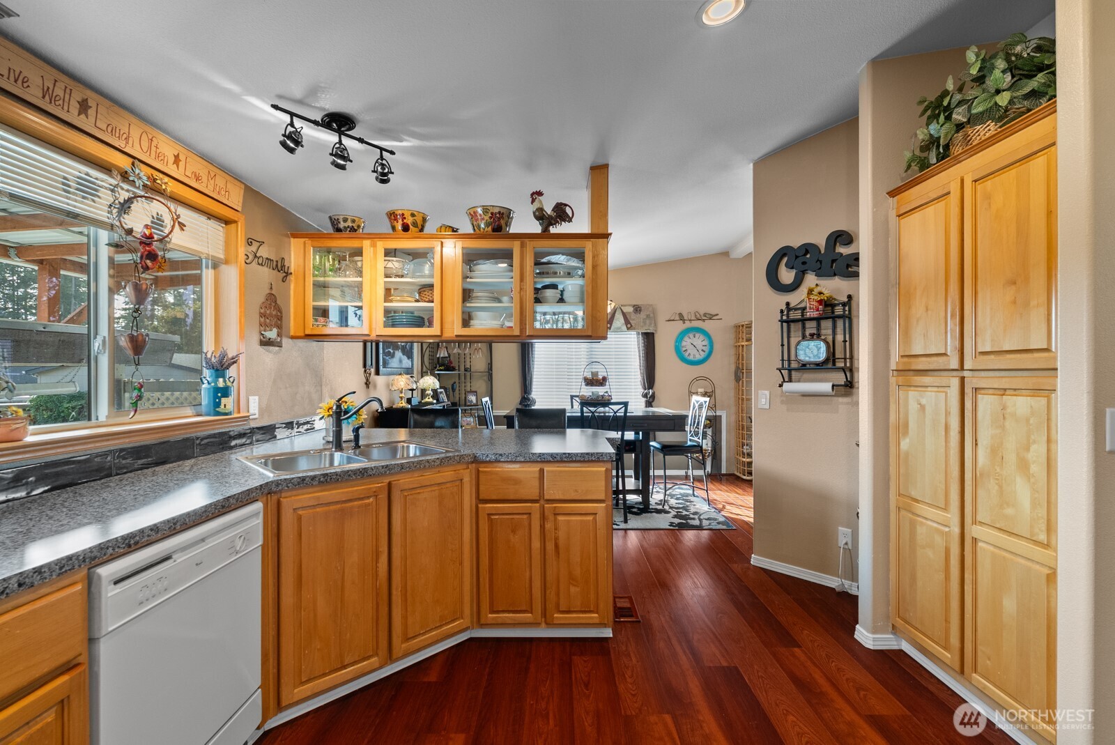 9314 Canyon Road East, Unit 39 Puyallup, WA 98371 - Photo 6 of 27 a kitchen with stainless steel appliances granite countertop wooden floors and sink