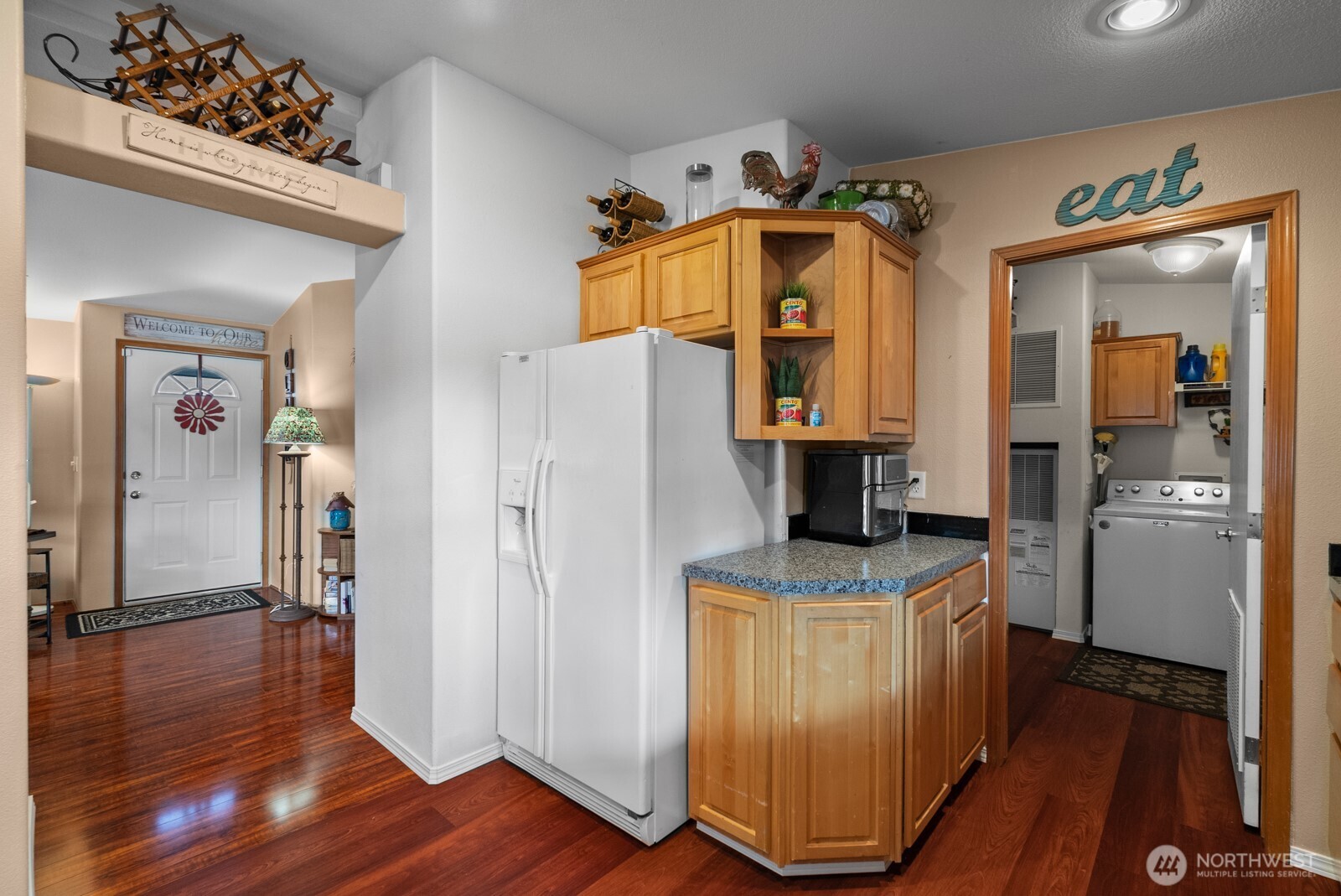 9314 Canyon Road East, Unit 39 Puyallup, WA 98371 - Photo 8 of 27 a kitchen view of a refrigerator and a wooden floor