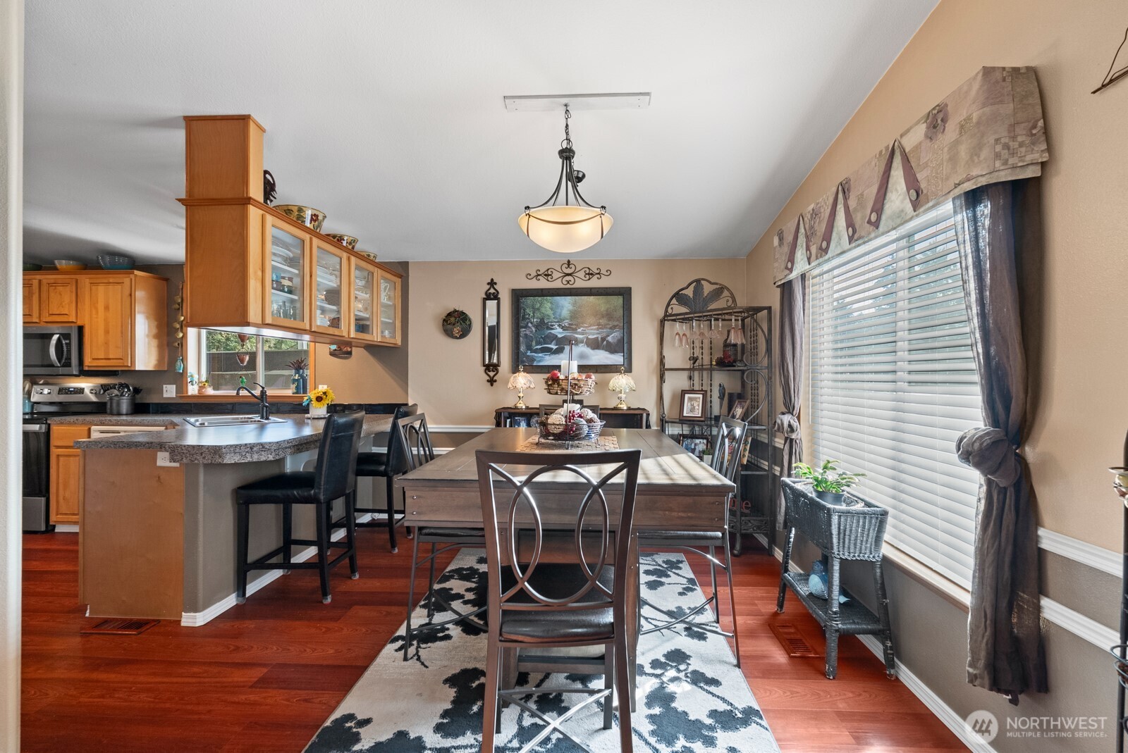 9314 Canyon Road East, Unit 39 Puyallup, WA 98371 - Photo 9 of 27 a view of a dining room with furniture window and wooden floor