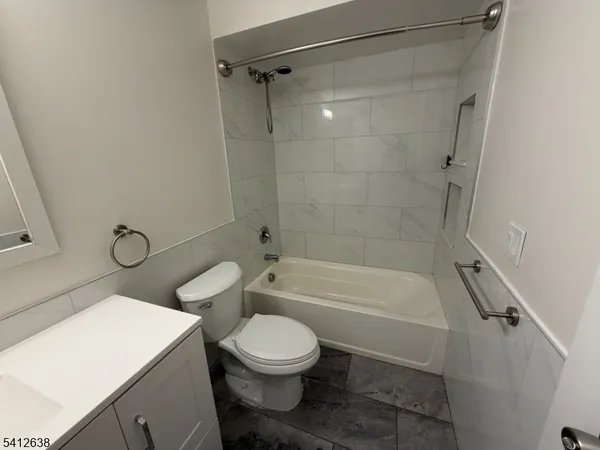 a bathroom with a toilet sink and shower