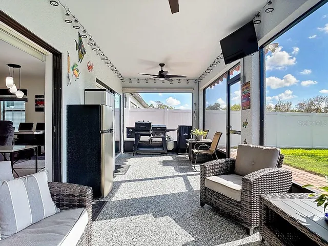 a living room with furniture fireplace and a large window