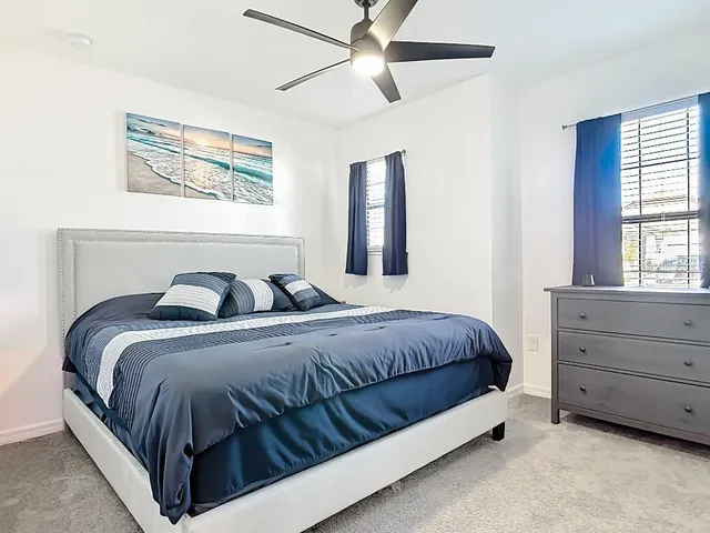 a bedroom with a bed and window