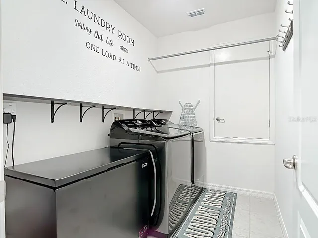 a view of a storage & utility room with racks on the wall