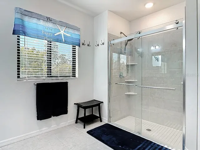 a bathroom with a shower and a mirror