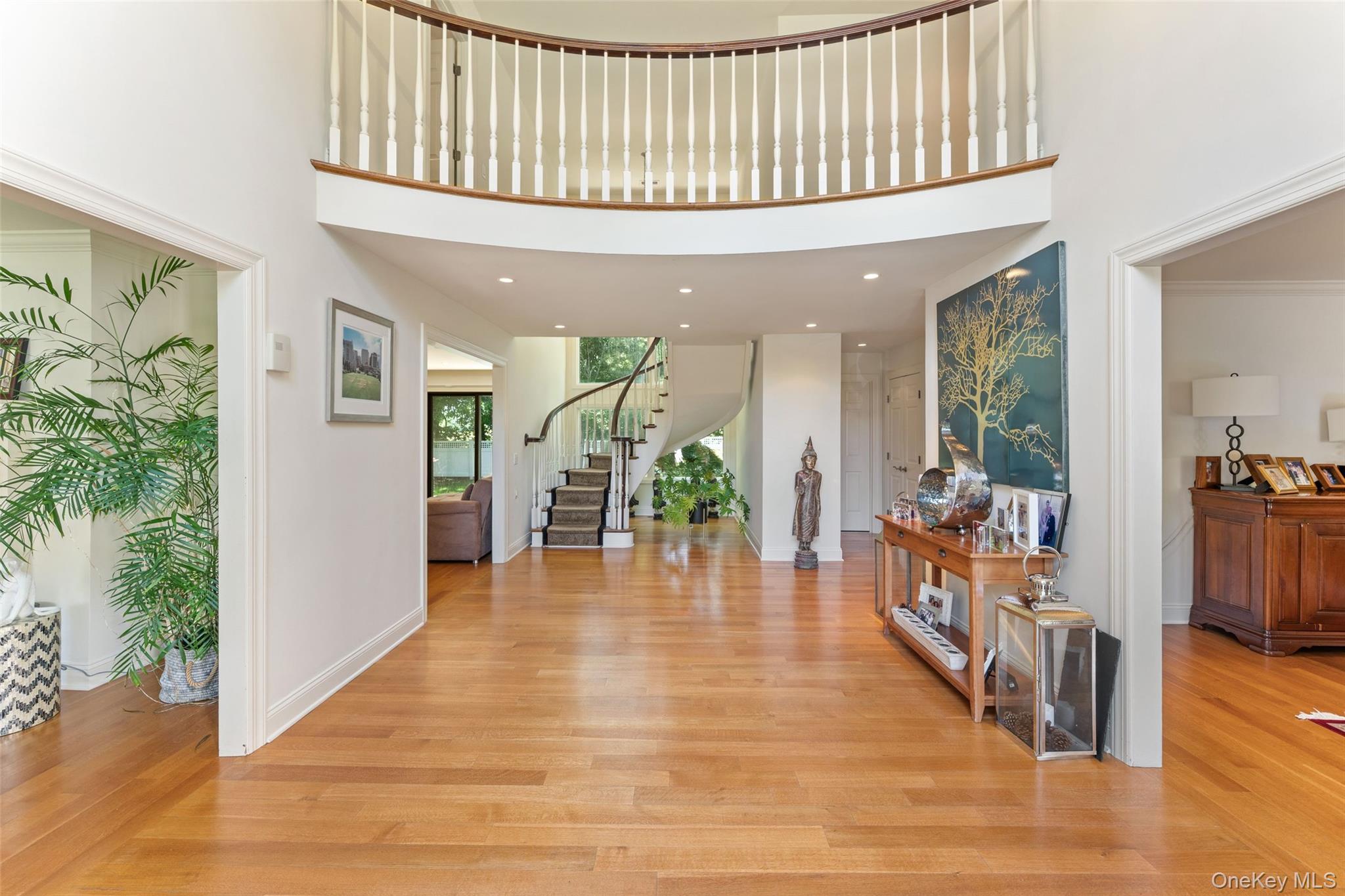 6 Magnetti Circle Mamaroneck, NY 10543 - Photo 2 of 24 a hallway with dining room and wooden floor