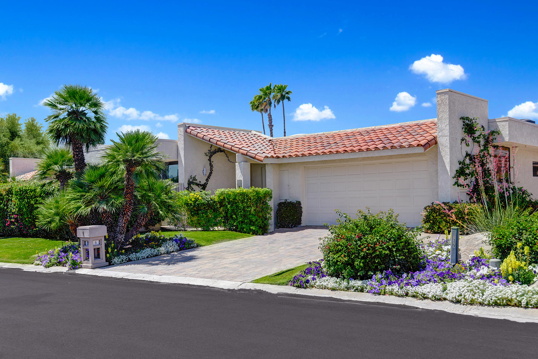 a front view of a house with a yard and a garage