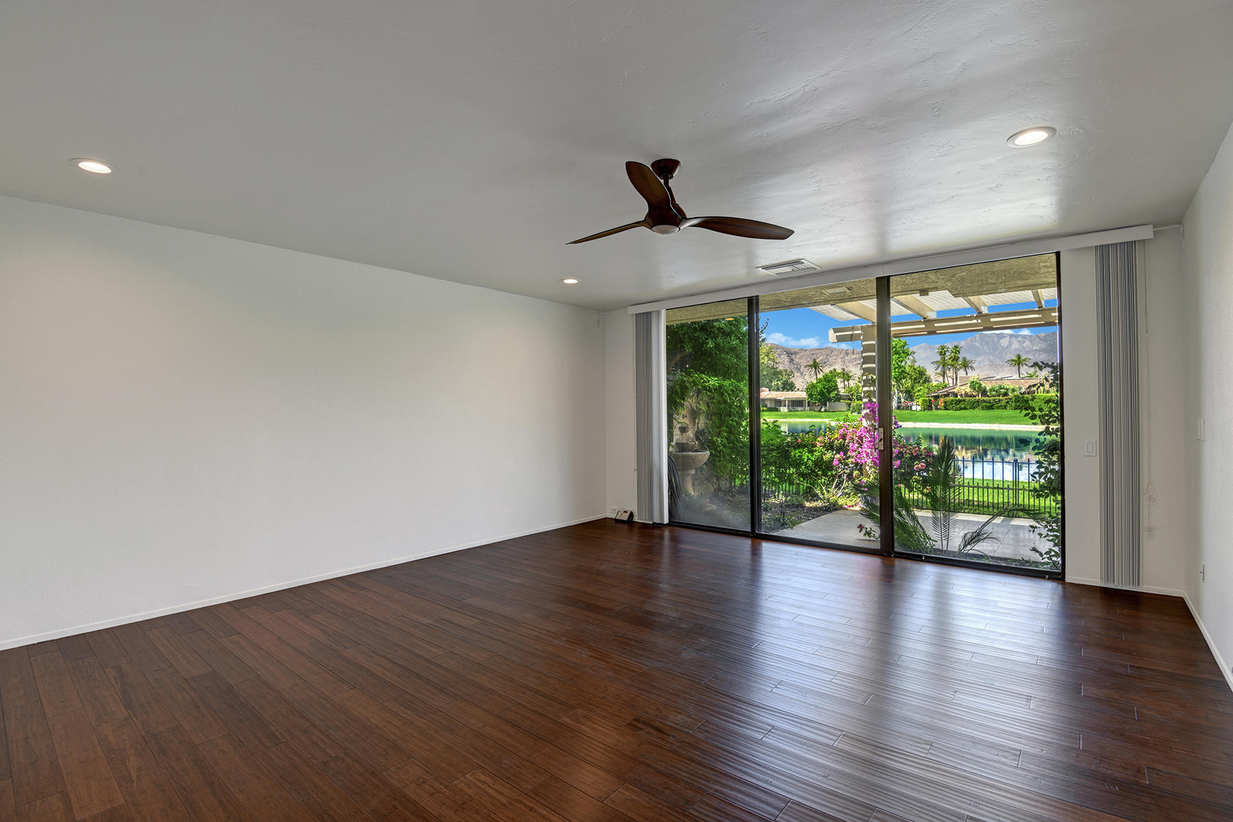 6 Colgate Drive Rancho Mirage, CA 92270 - Photo 12 of 32 a view of an empty room with wooden floor and a window