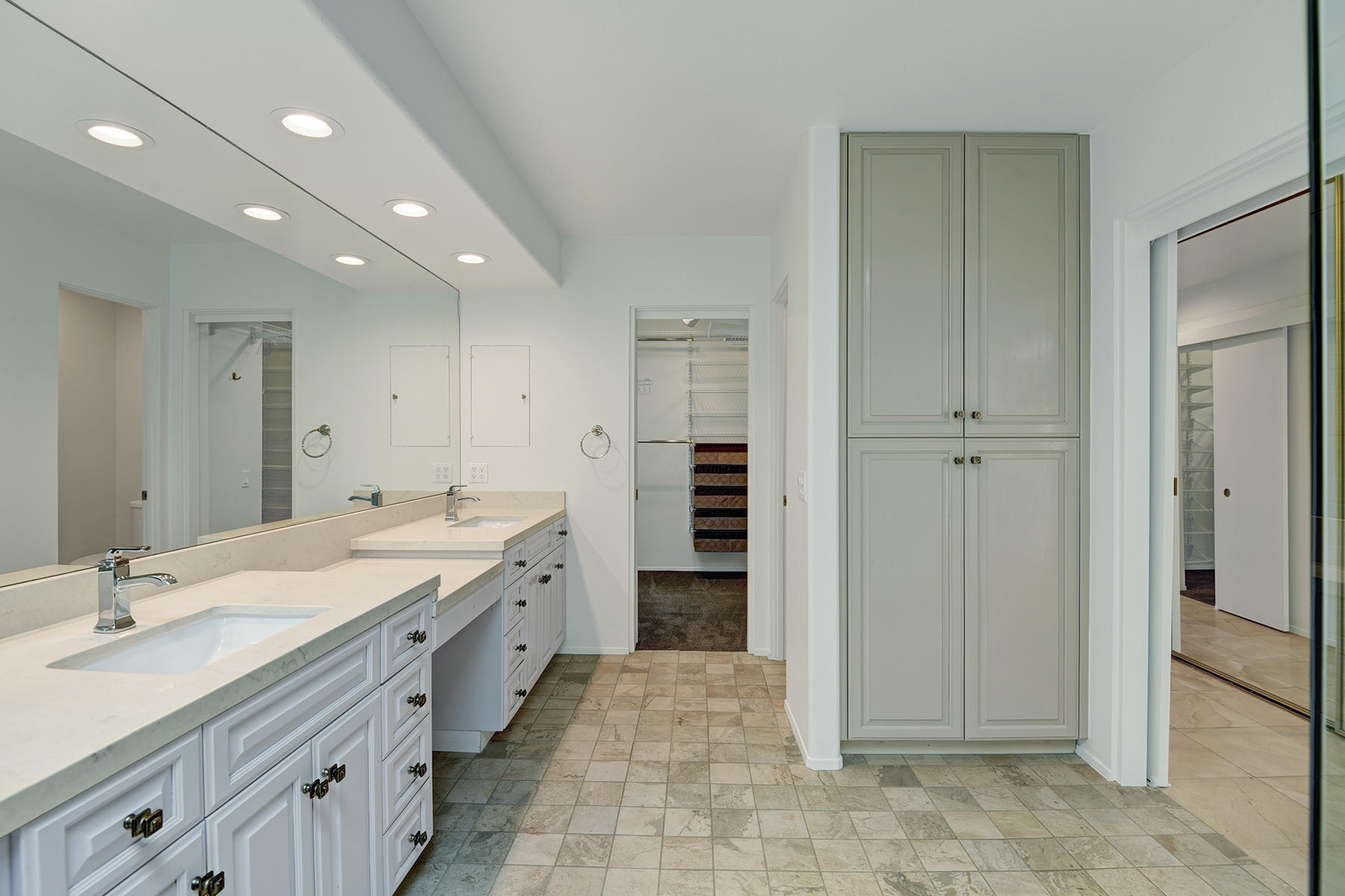 6 Colgate Drive Rancho Mirage, CA 92270 - Photo 15 of 32 a spacious bathroom with a double vanity sink a and a mirror