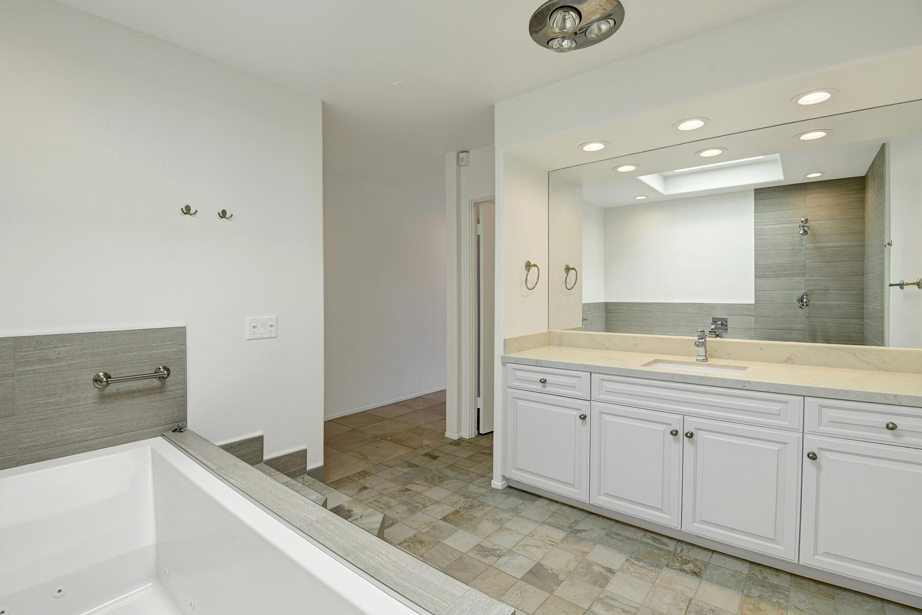 6 Colgate Drive Rancho Mirage, CA 92270 - Photo 17 of 32 a spacious bathroom with a granite countertop sink and a mirror