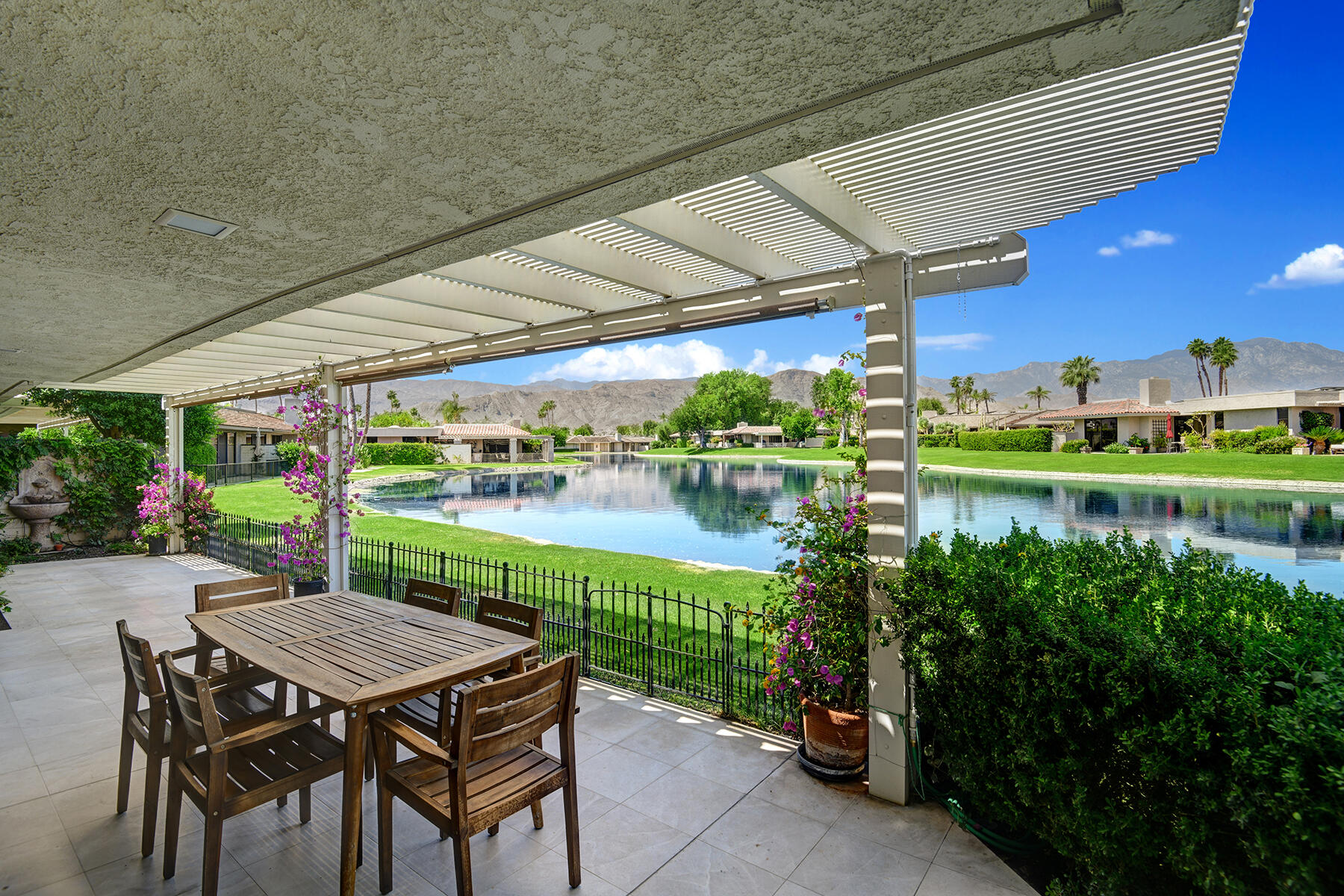 6 Colgate Drive Rancho Mirage, CA 92270 - Photo 20 of 32 a view of a chairs and table in patio with a lake view