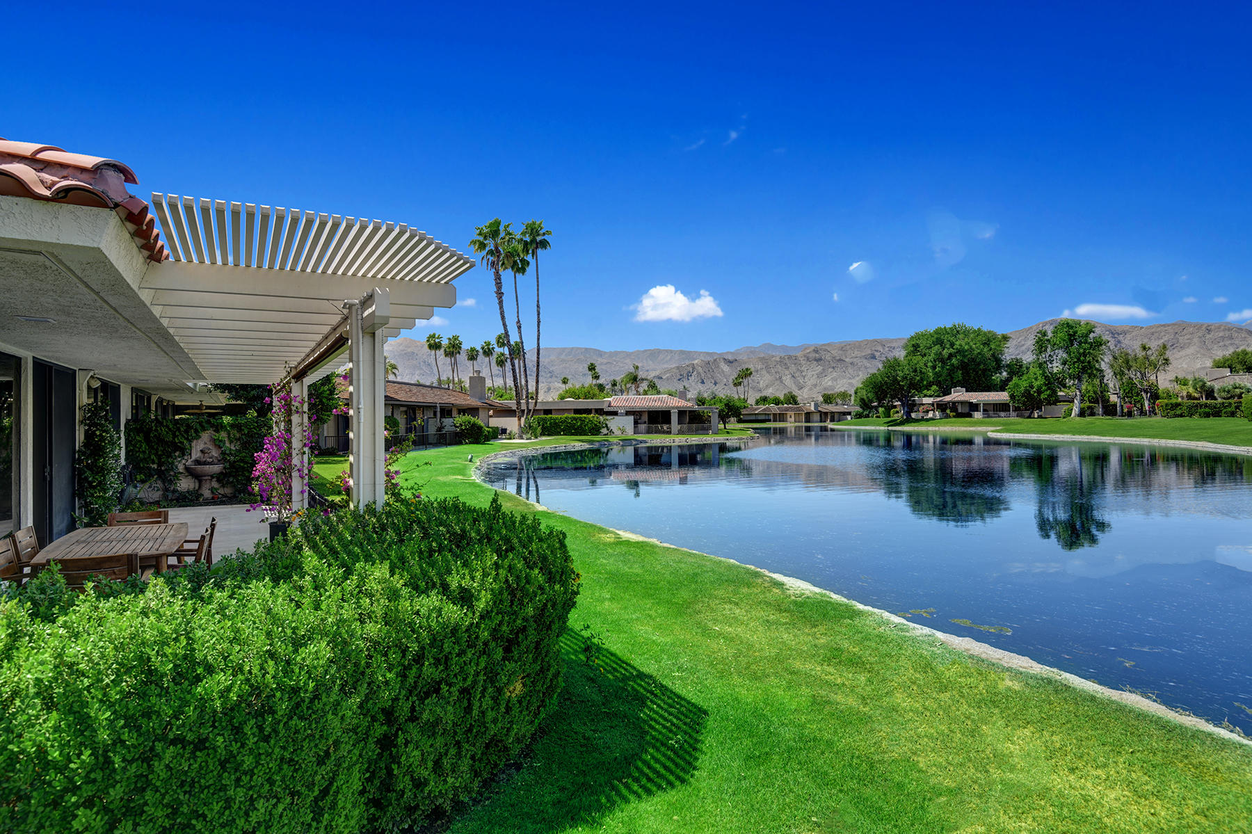 6 Colgate Drive Rancho Mirage, CA 92270 - Photo 23 of 32 a view of a house with swimming pool next to a yard