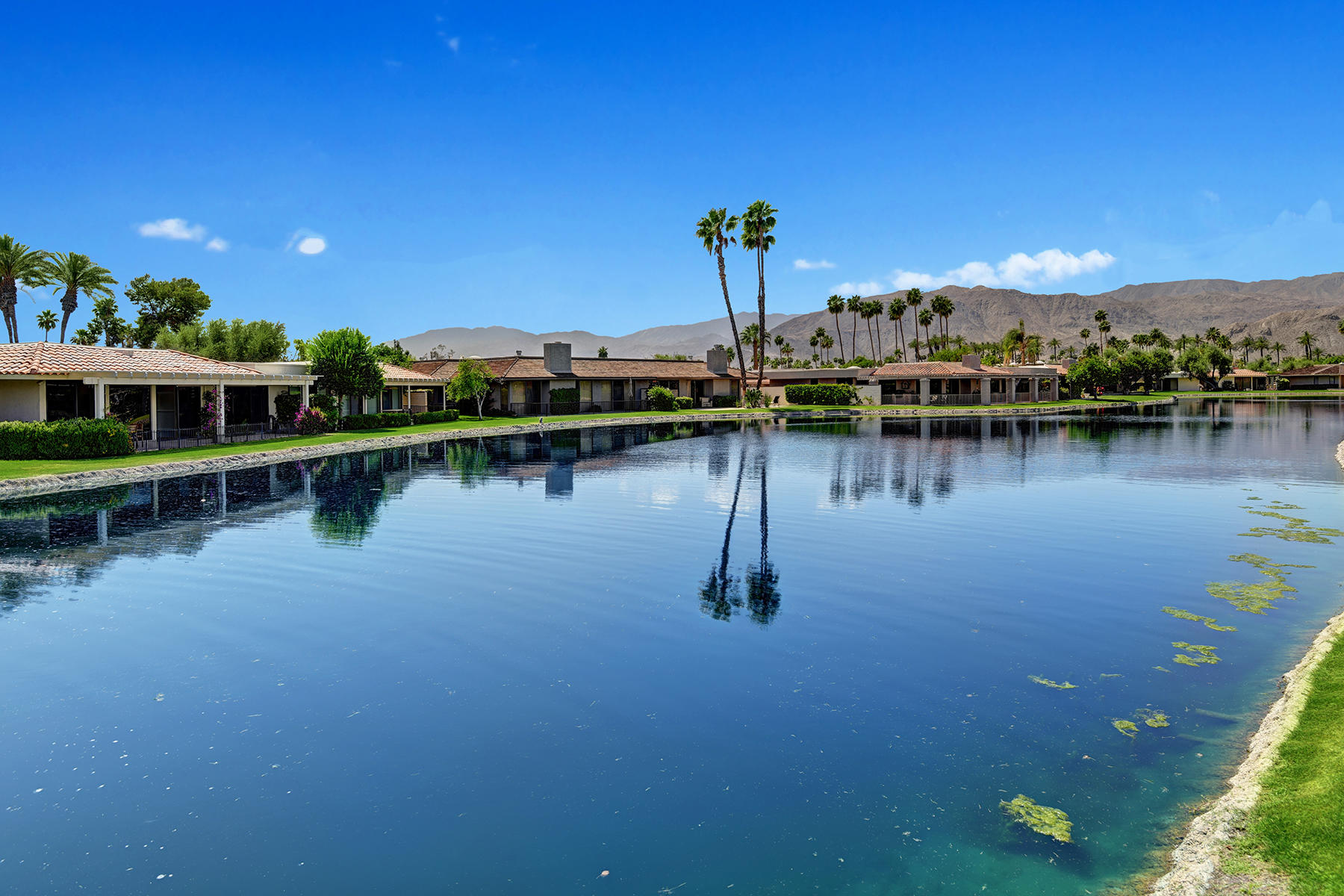6 Colgate Drive Rancho Mirage, CA 92270 - Photo 25 of 32 a view of a lake with boats and trees in the background