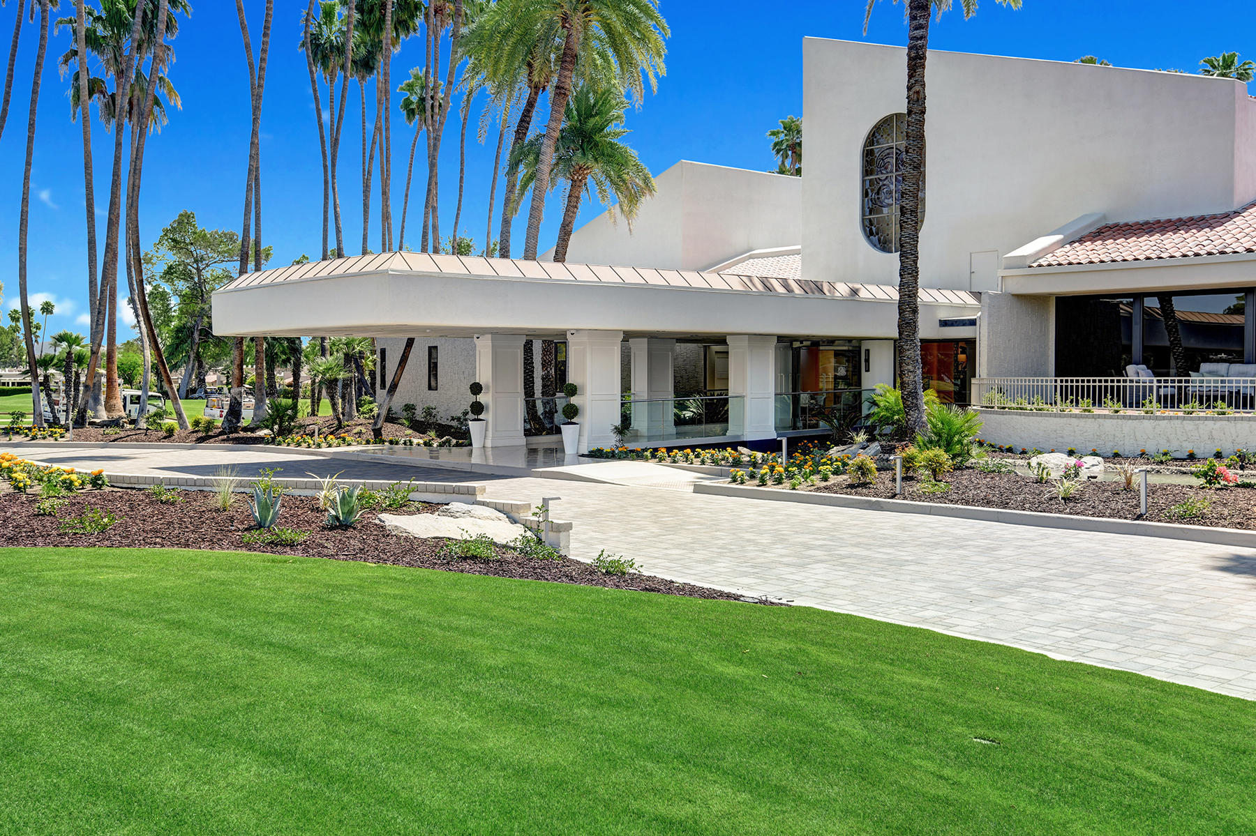 6 Colgate Drive Rancho Mirage, CA 92270 - Photo 27 of 32 a front view of a house with swimming pool and a table and chairs