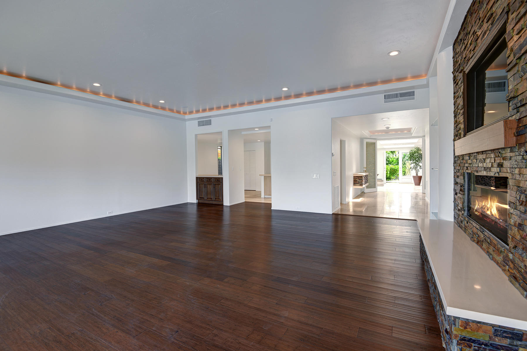 6 Colgate Drive Rancho Mirage, CA 92270 - Photo 5 of 32 an empty room with wooden floor fireplace and windows