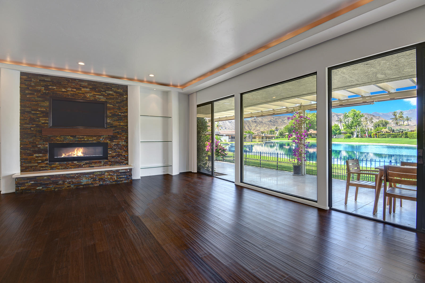 6 Colgate Drive Rancho Mirage, CA 92270 - Photo 6 of 32 a view of an empty room with wooden floor and a fireplace