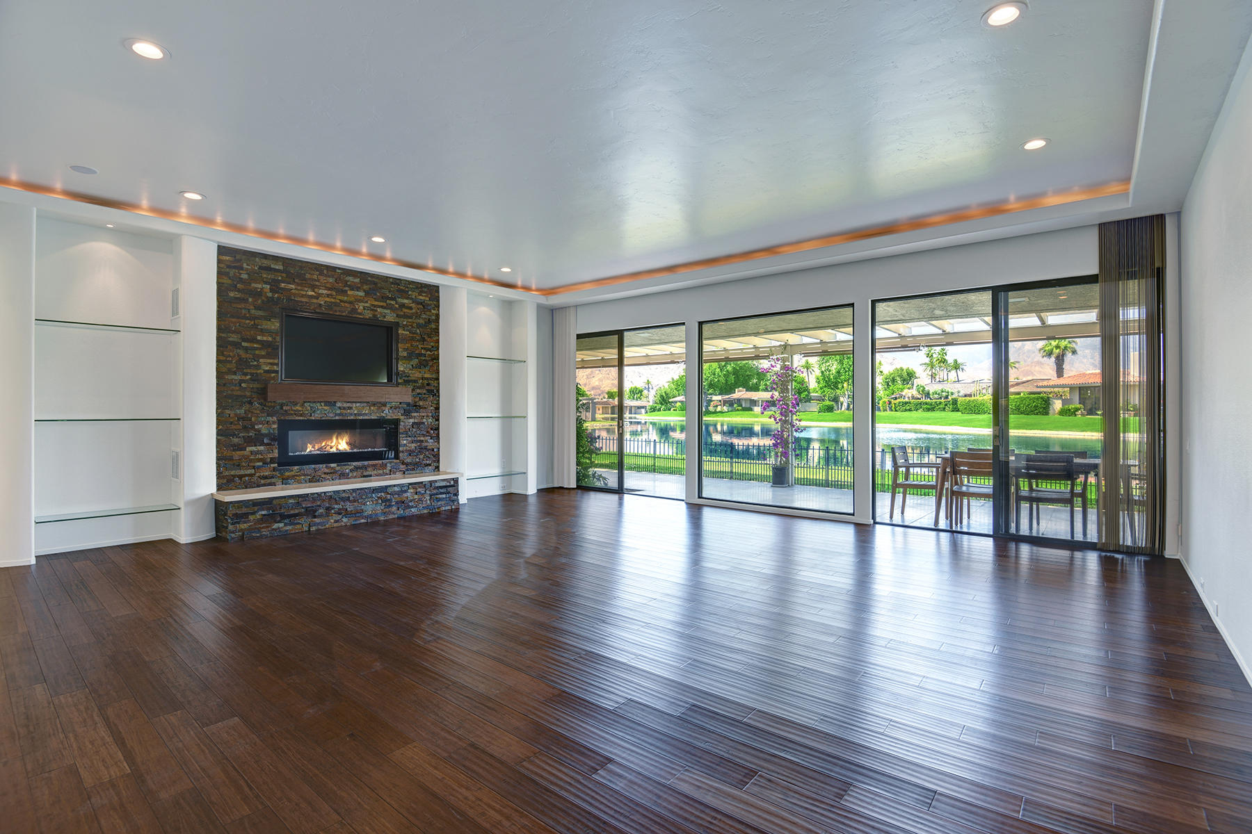 6 Colgate Drive Rancho Mirage, CA 92270 - Photo 7 of 32 a view of an empty room with wooden floor and a window