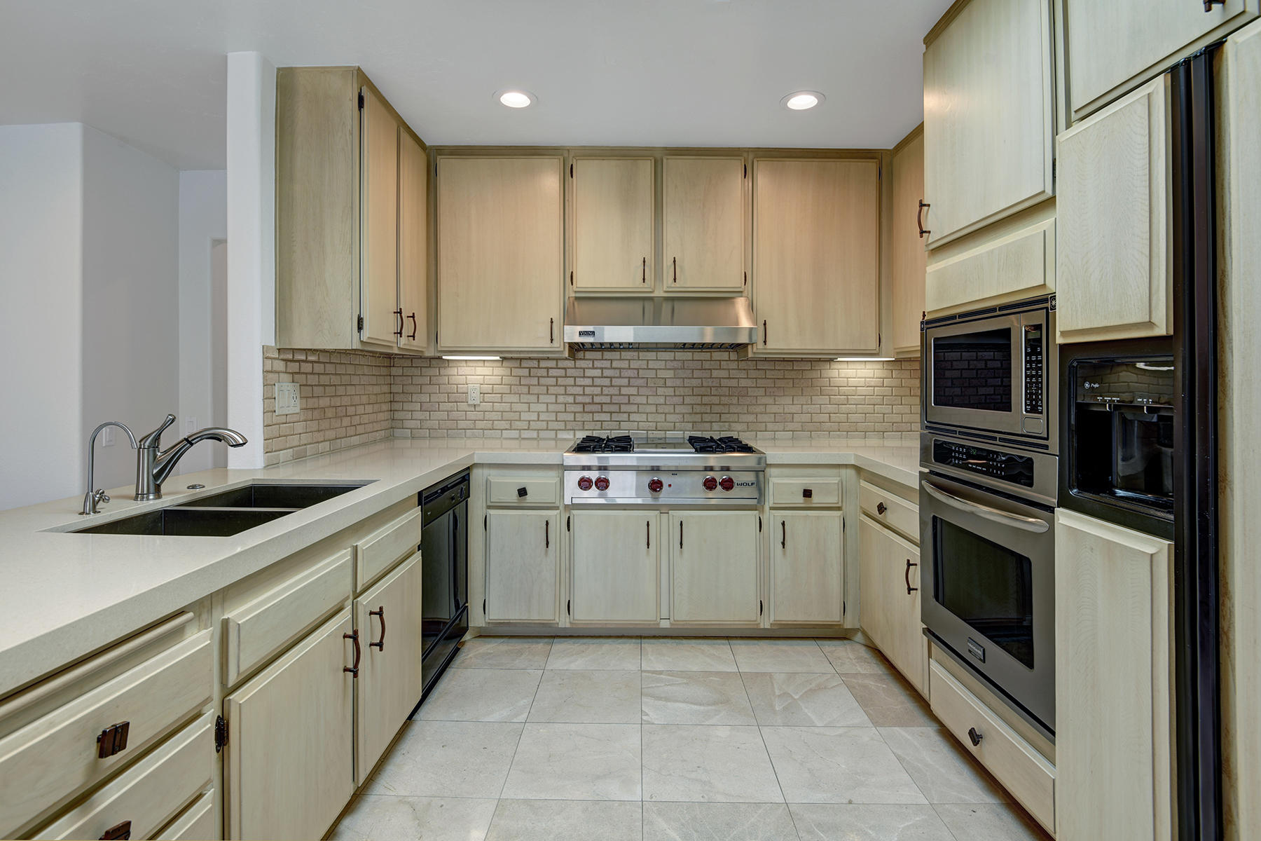 6 Colgate Drive Rancho Mirage, CA 92270 - Photo 8 of 32 a kitchen with stainless steel appliances granite countertop a stove a sink and a refrigerator