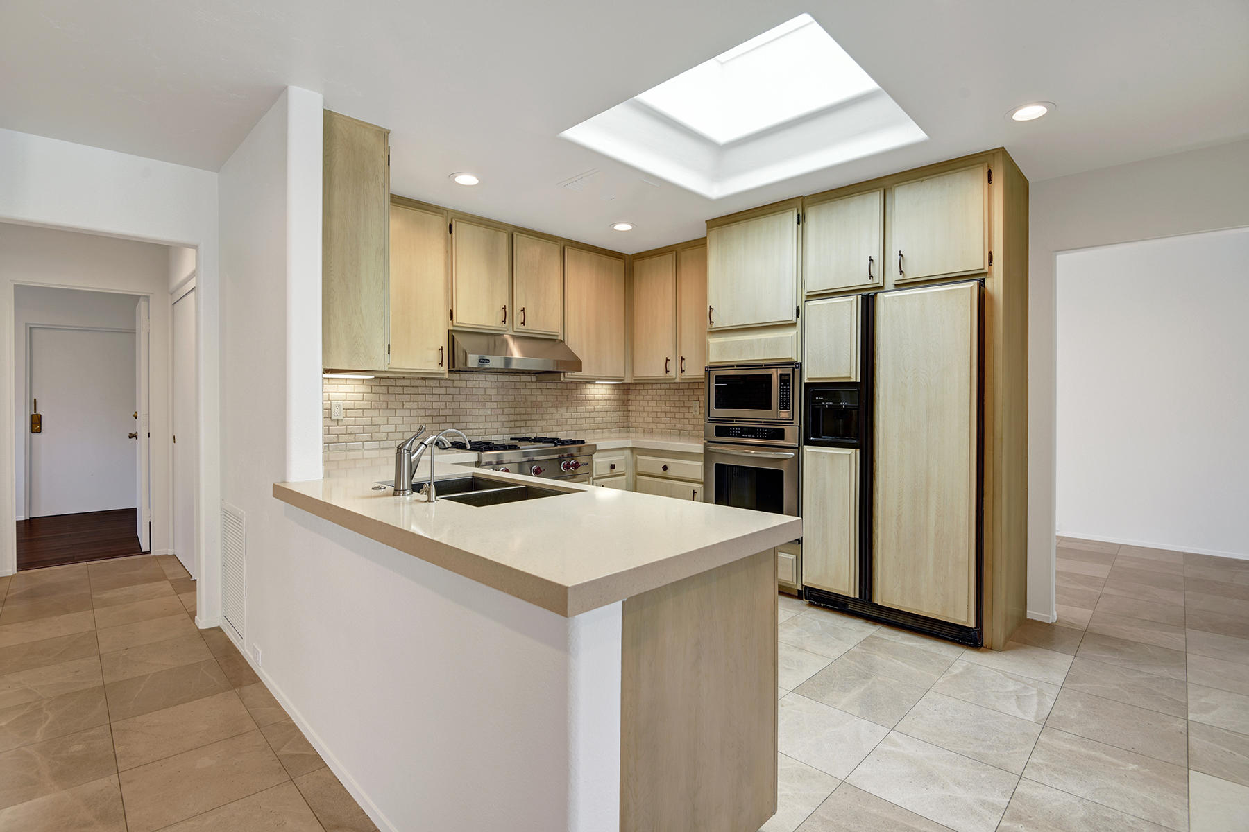 6 Colgate Drive Rancho Mirage, CA 92270 - Photo 9 of 32 a kitchen with a sink stainless steel appliances and counter space