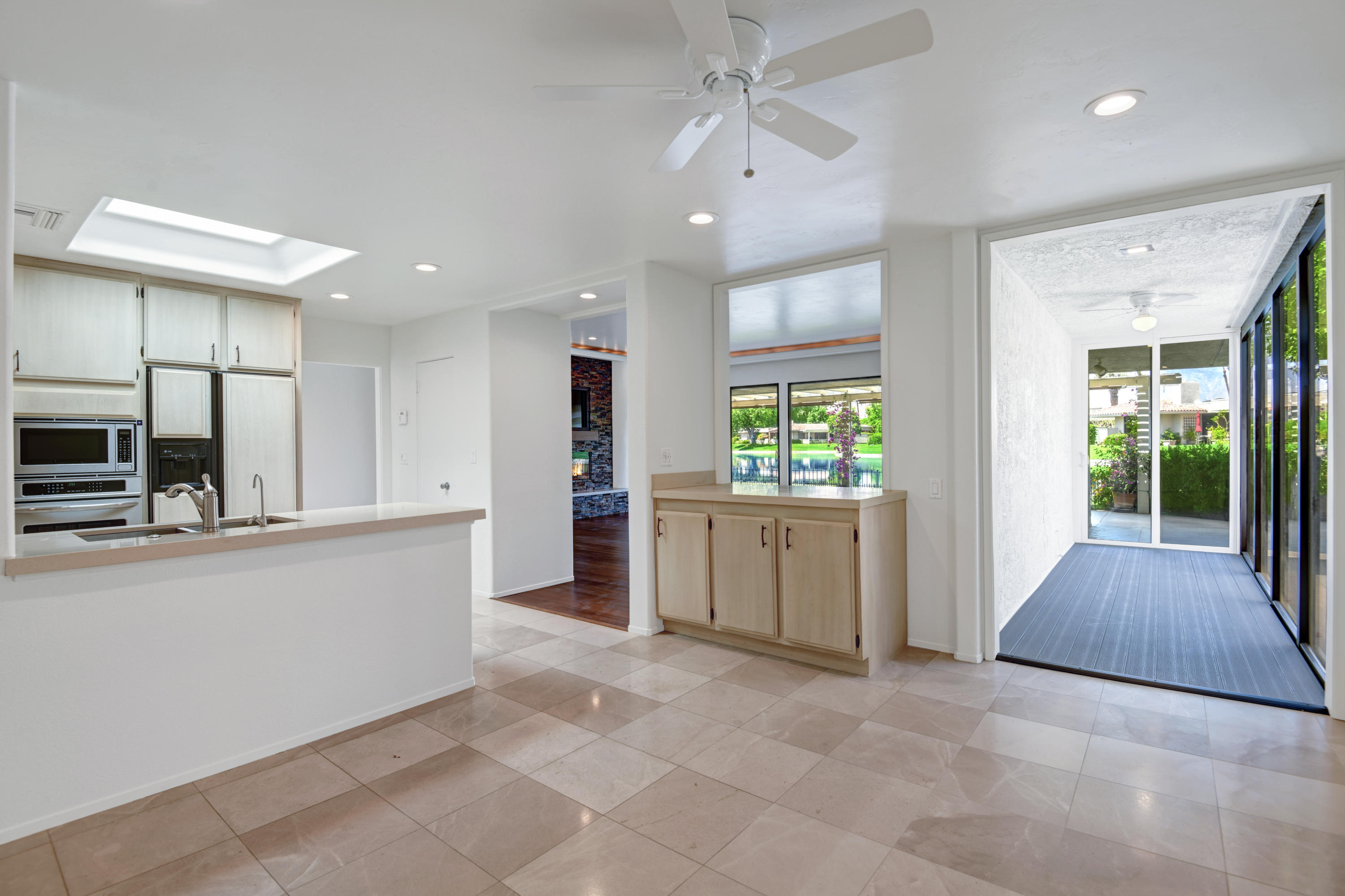 6 Colgate Drive Rancho Mirage, CA 92270 - Photo 10 of 32 a large white kitchen with lots of counter space and appliances