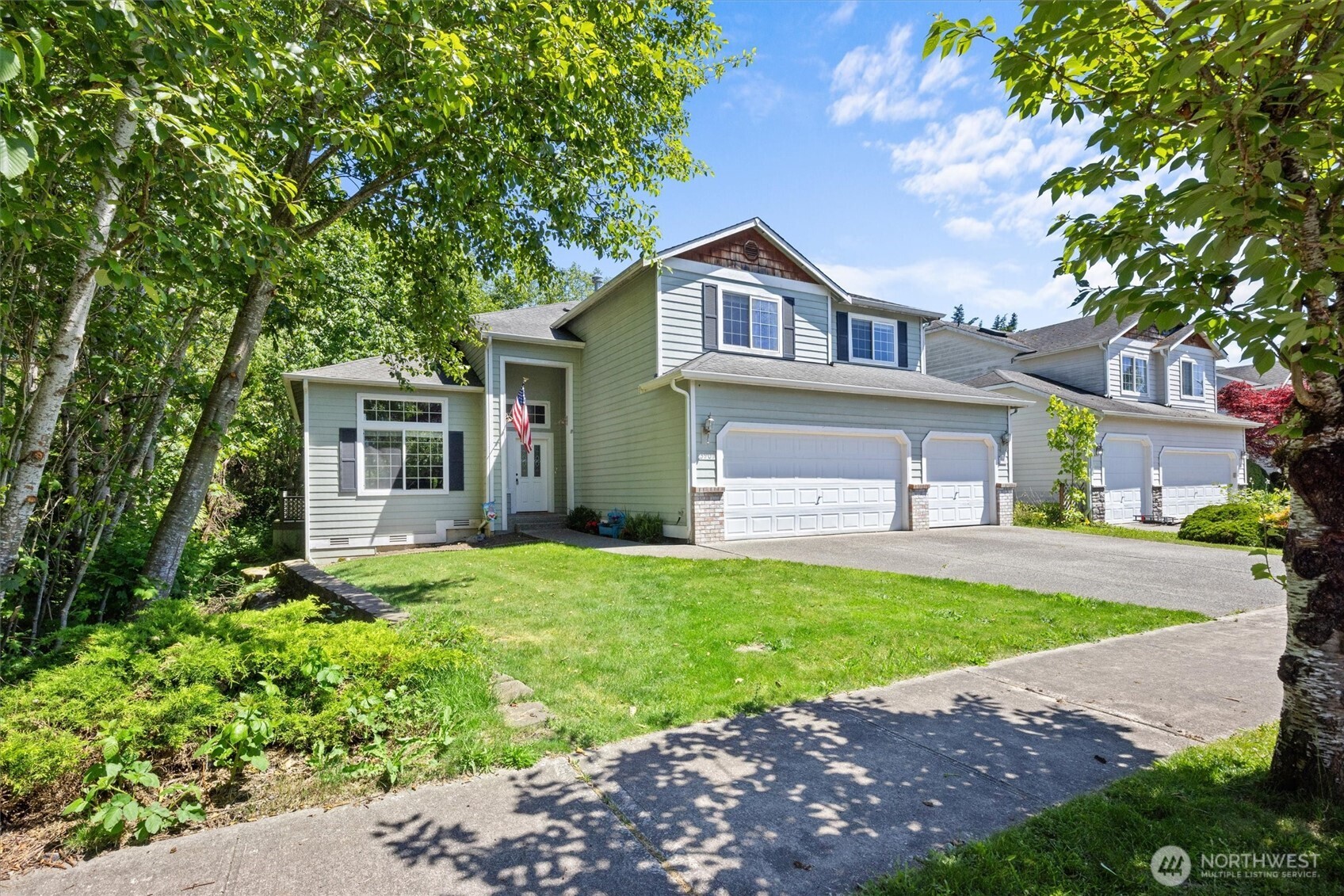 a front view of a house with a yard and garage