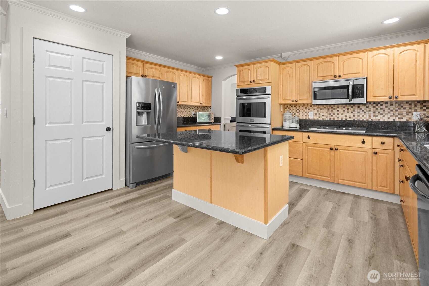 13901 Cedar Court Sultan, WA 98294 - Photo 11 of 34 a kitchen with stainless steel appliances granite countertop a refrigerator a stove top oven a sink and dishwasher with wooden floor