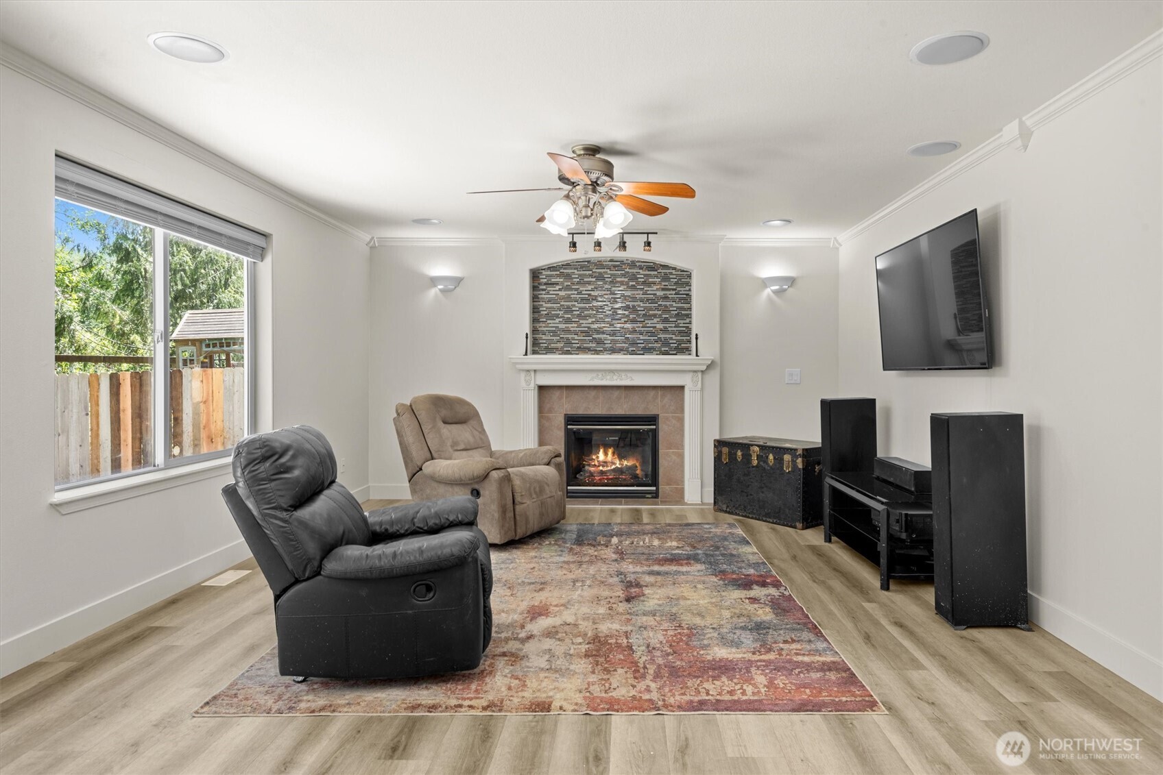 13901 Cedar Court Sultan, WA 98294 - Photo 14 of 34 a living room with furniture a flat screen tv and a fireplace