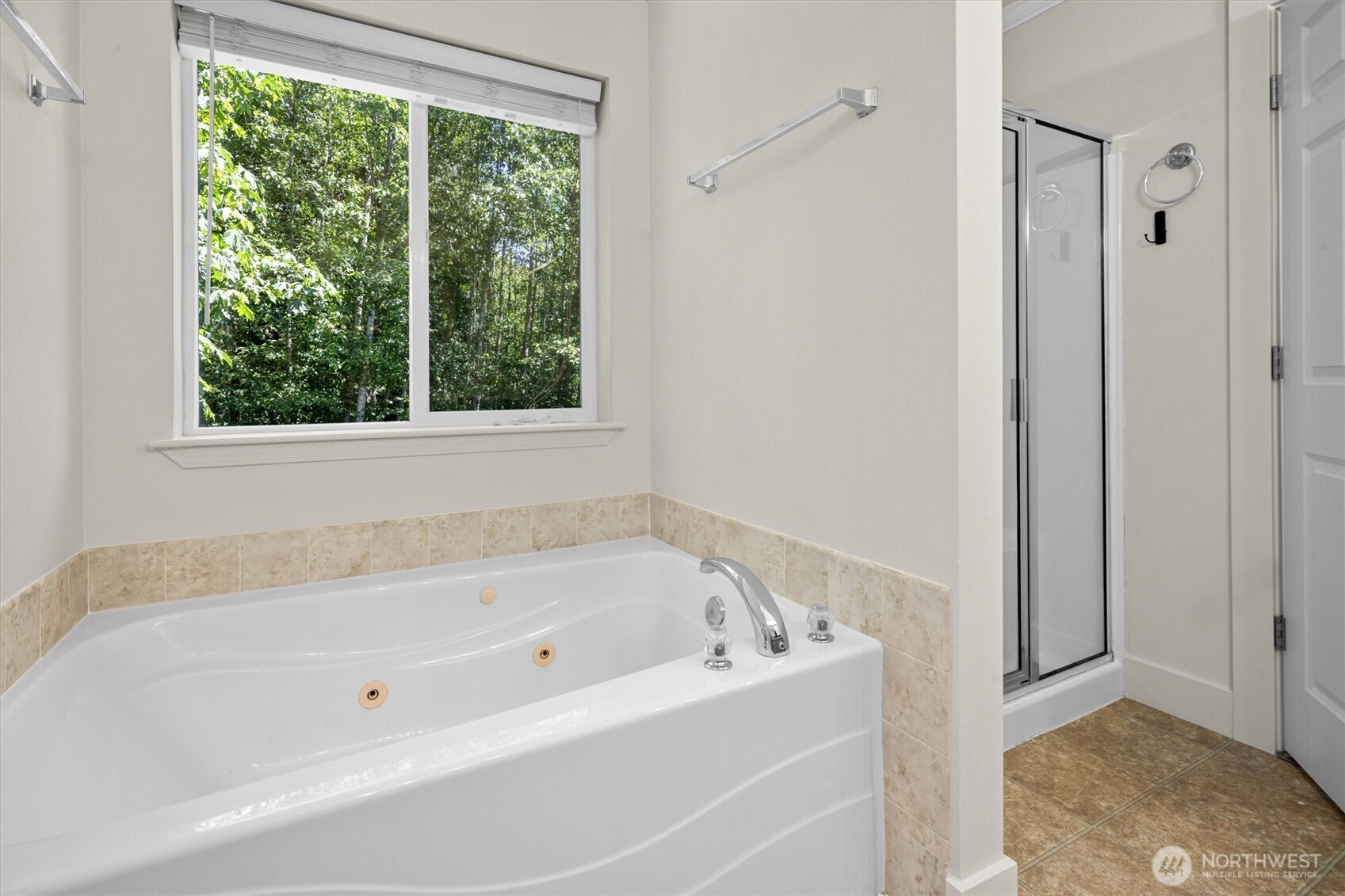 13901 Cedar Court Sultan, WA 98294 - Photo 18 of 34 a white bath tub sitting in a bathroom next to a window