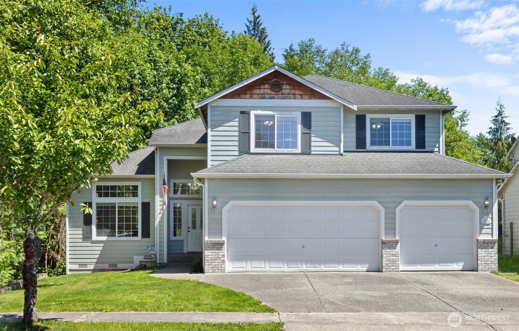 13901 Cedar Court Sultan, WA 98294 - Photo 2 of 34 a front view of a house with a garden and plants