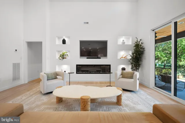 a living room with furniture a large window and a fireplace