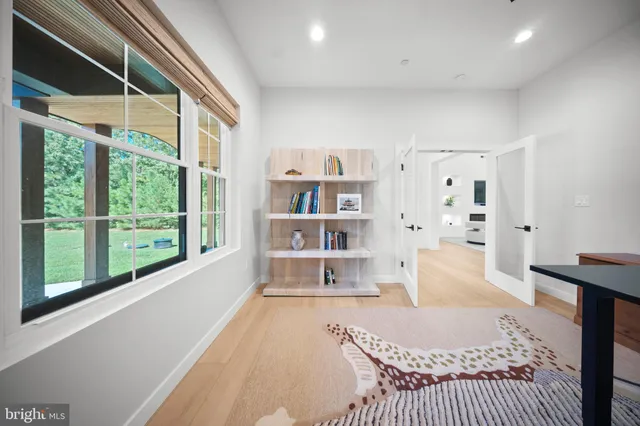 an aerial view of residential houses with outdoor space and lake view