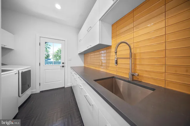 an aerial view of a house with a garden and lake view