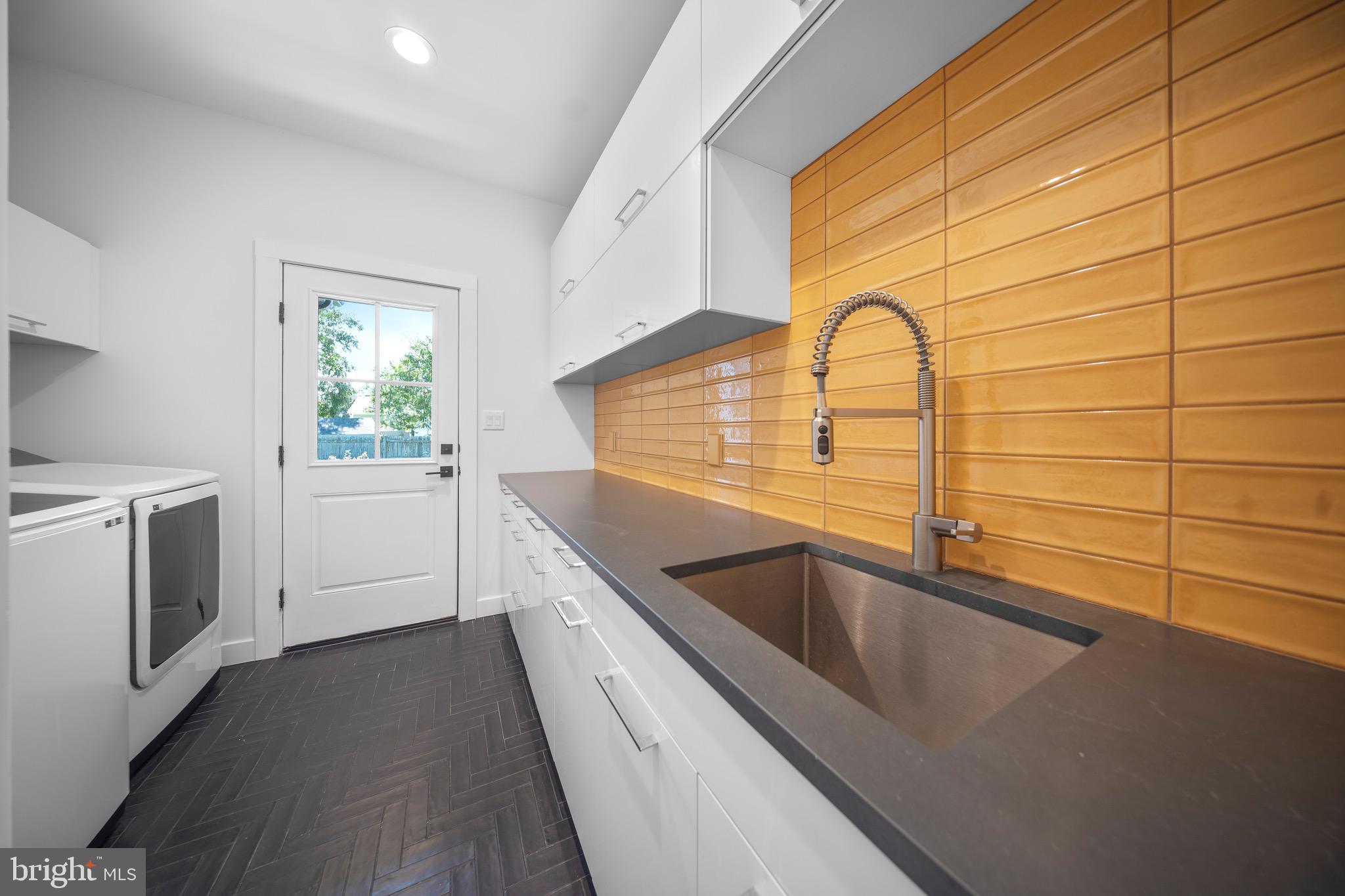 3311 Redden Ferry Road Eden, MD 21822 - Photo 50 of 75 a view of a kitchen with a sink and dishwasher with wooden floor