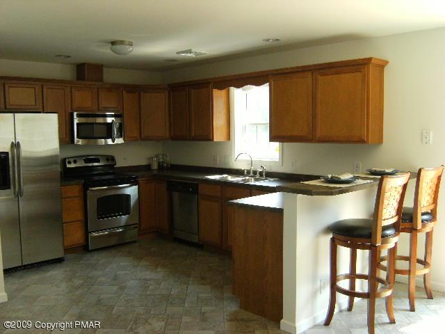 Lot 23 Legion Road Kunkletown, PA 18058 - Photo 14 of 14 a kitchen with granite countertop a stove a sink and a microwave